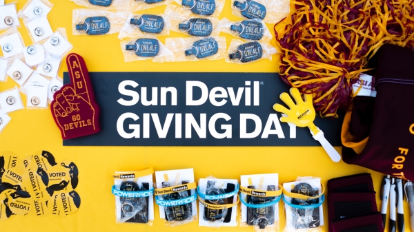 ASU swag on a table that says Sun Devil Giving Day